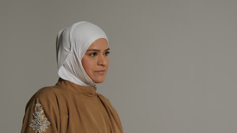 Studio-Head-And-Shoulders-Portrait-Of-Smiling-Muslim-Woman-Wearing-Hijab-1